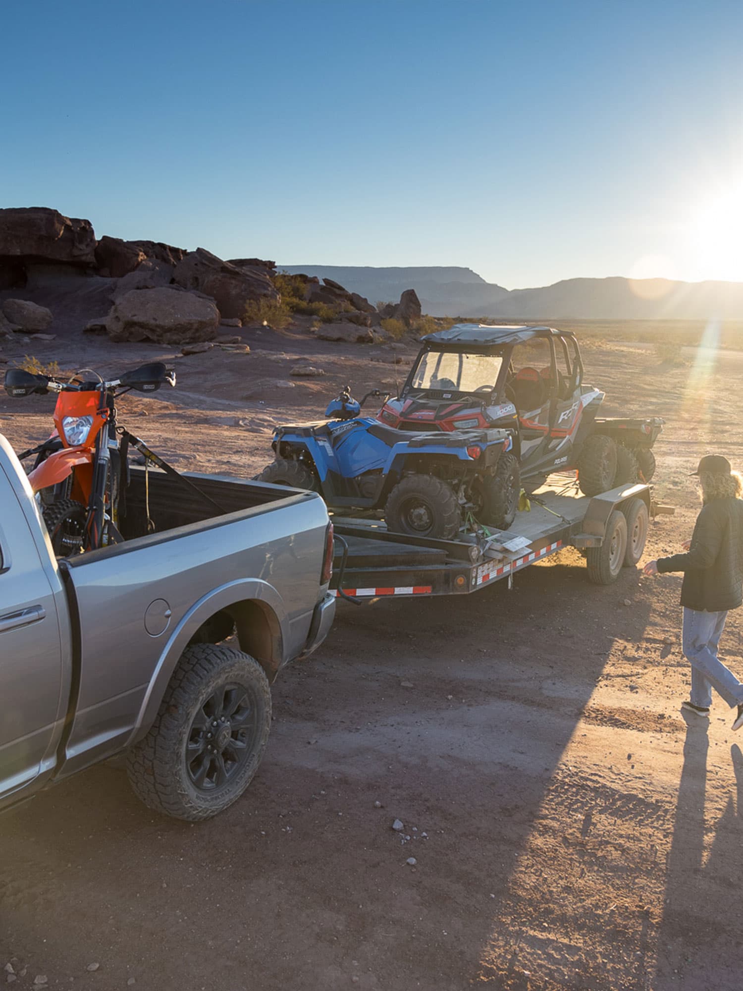 Truck hauling motorbike and  ATVs