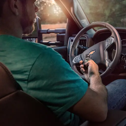 Man sitting in truck using WirelessOne controller